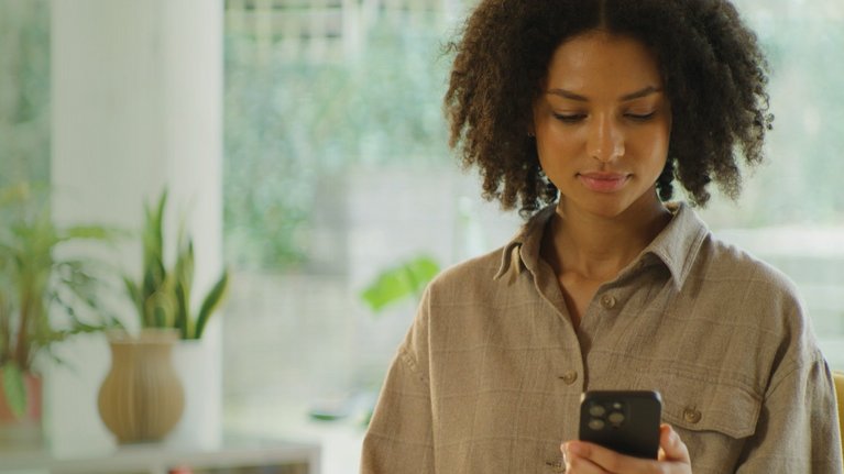 Woman looks at her cell phone
