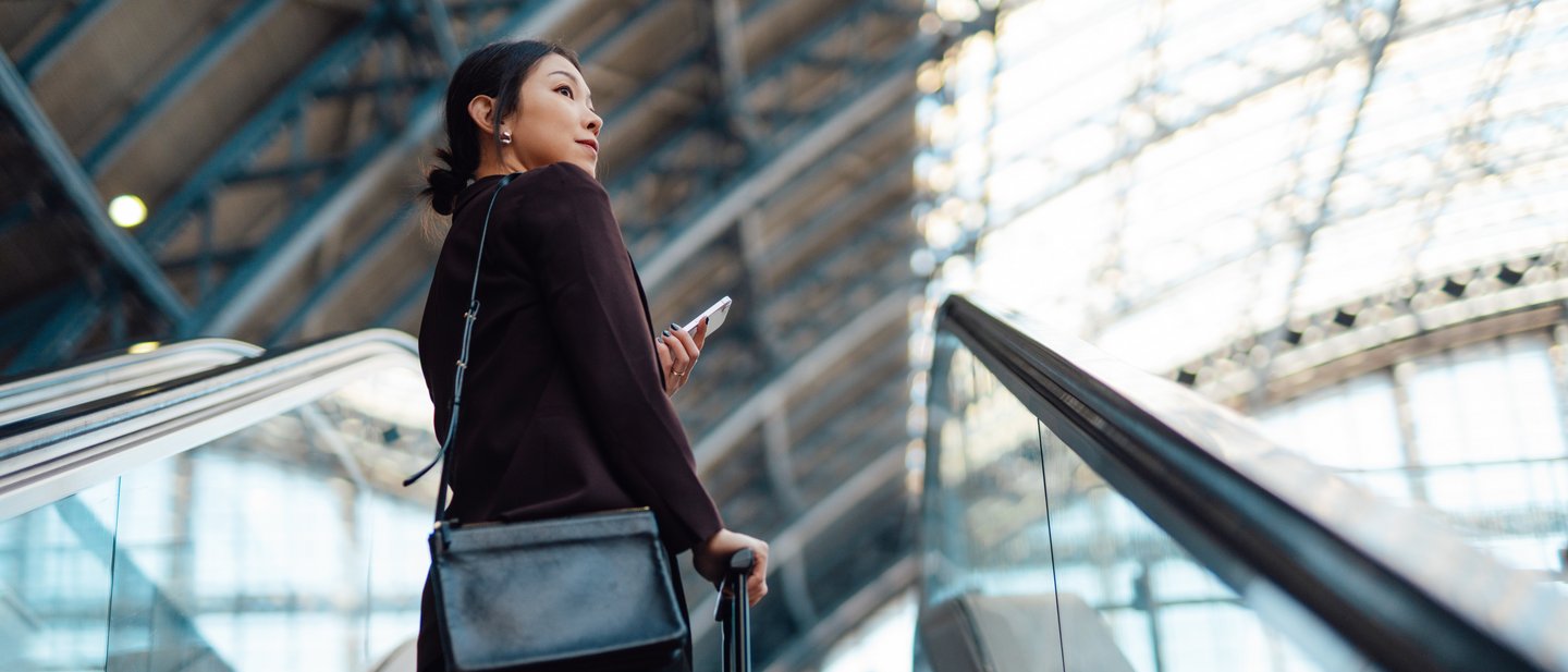 Woman travelling with cellphone at airport