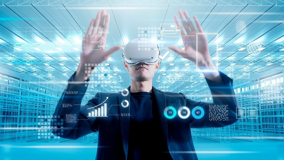 Man with VR glasses looks at a holographic model
