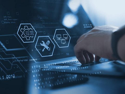 Technician works on laptop to manage database, big data and digital technologies.