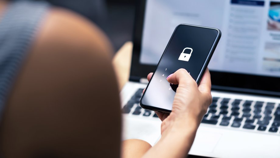 Person unlocking the screen of their mobile phone.