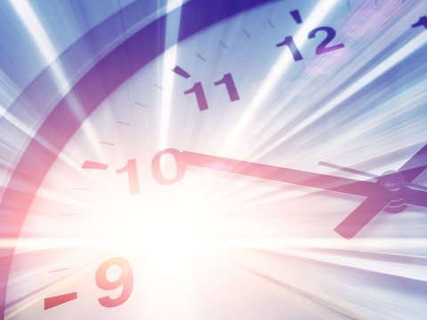 Blurred, dynamic close-up of a clock with light streaks symbolizing motion and time travel.