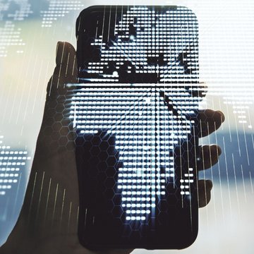 Hand holding a smartphone with a digital world map showing Africa in the center