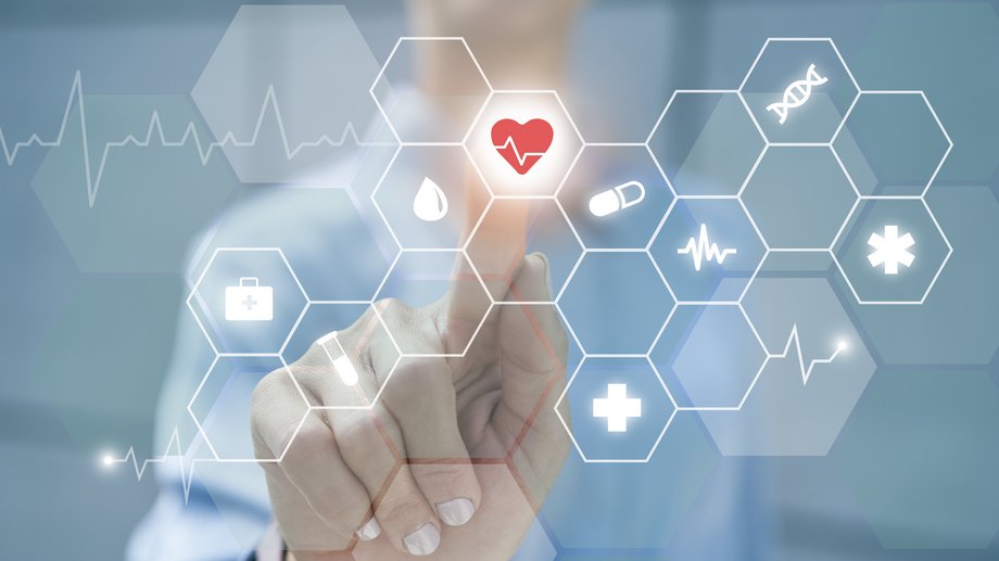 Hand touches virtual medical interface with symbols.