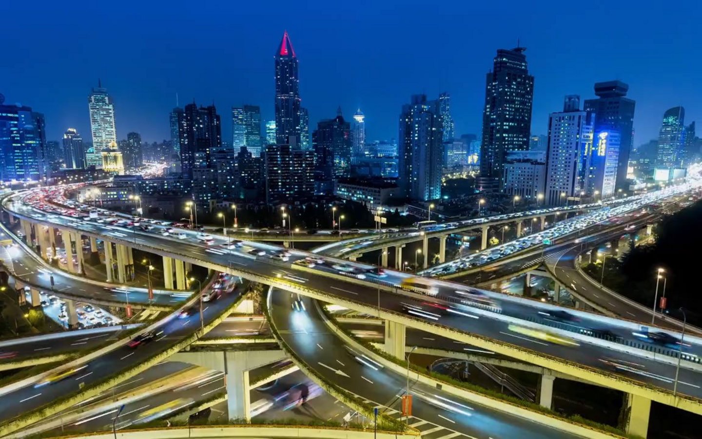 Rush hour traffic on multiple highways and flyovers at night illustrating connectivity.