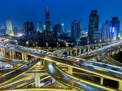 Rush hour traffic on multiple highways and flyovers at night illustrating connectivity.