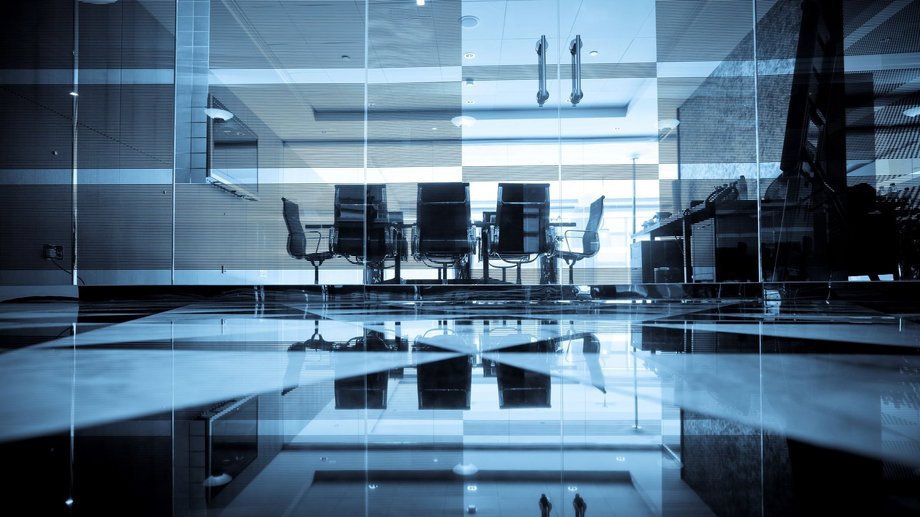 meeting room within a glassy and shiny office environment