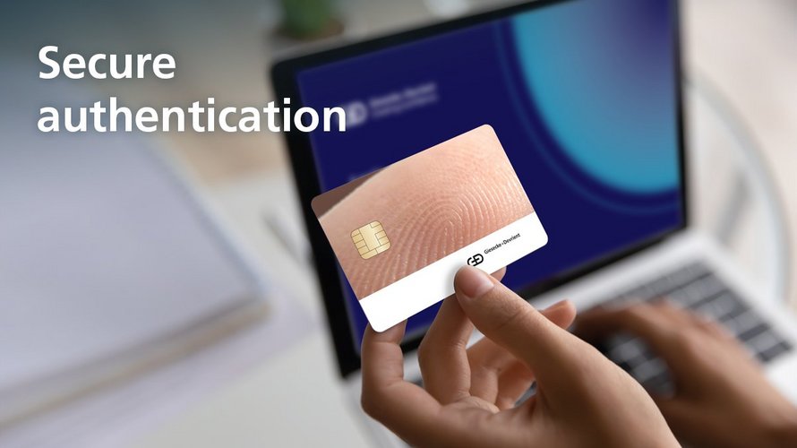 A person holds a Key Fob pointed at their laptop. The picture says 'Secure Authentication'.