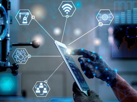 A hand interacting with a tablet, surrounded by digital symbols