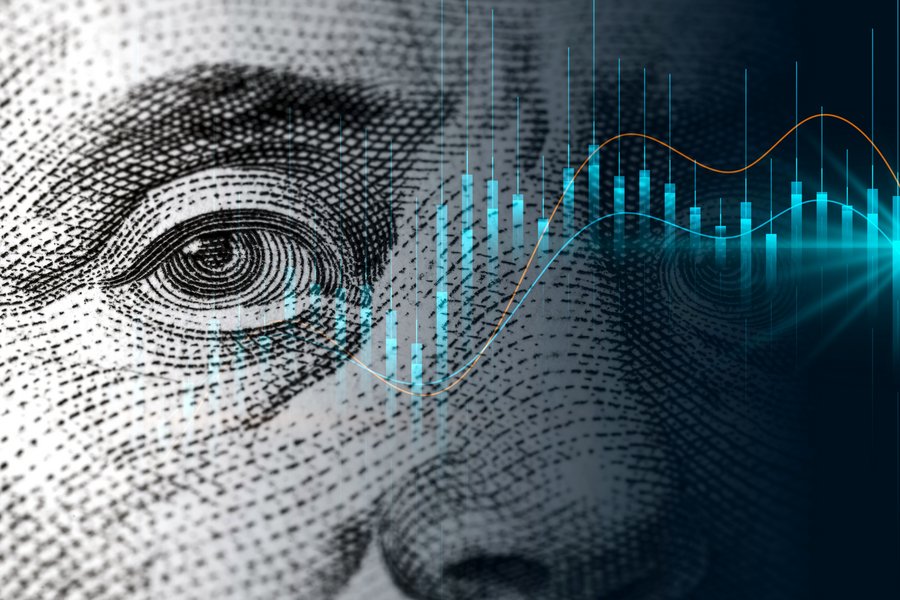 Chart of a stock in front of a zoomed in dollar-note