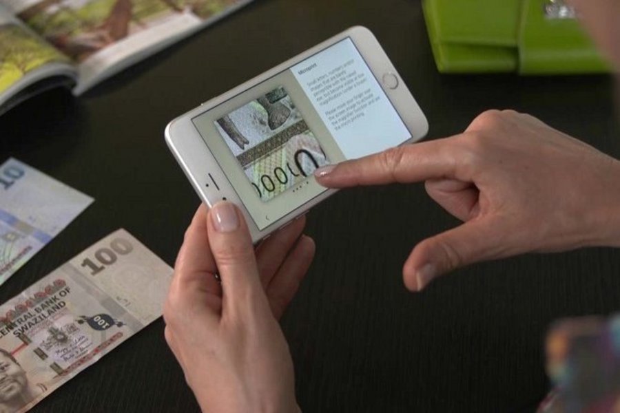 Development of currency, looking back at the currency union in Germany and Europe on a mobile.