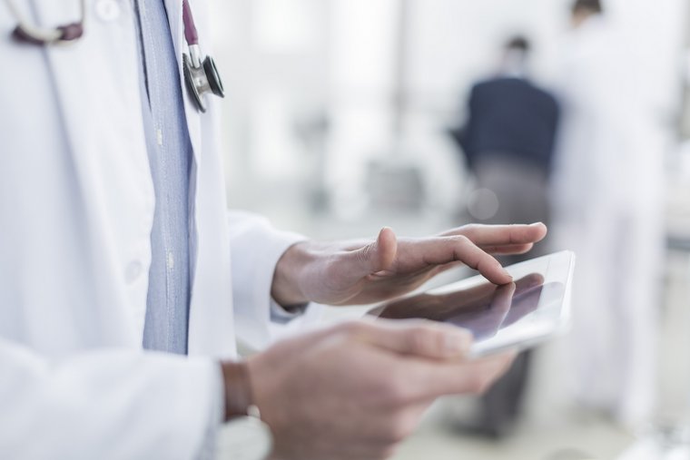 Doctor using a tablet in a medical setting