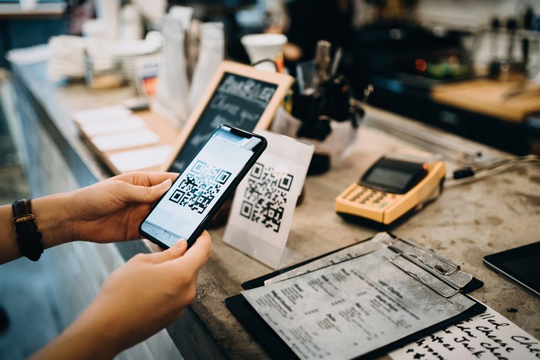 A woman pays with her smartphone in a shop