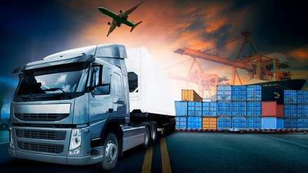 Truck with container port in the background and airplane in the sky