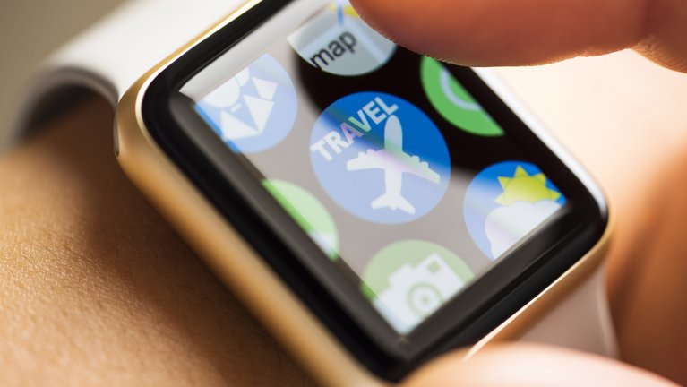 Close-up of the screen of a smartwatch with an icon for a travel app