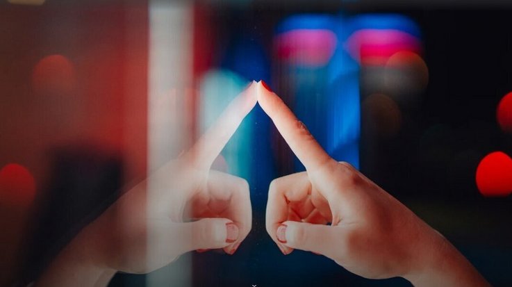 finger touching an illuminated surface