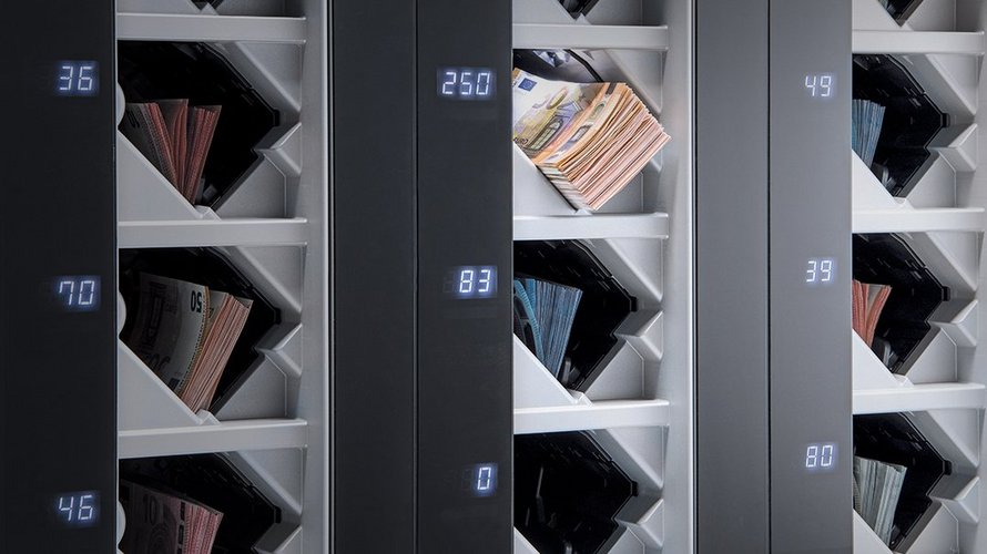 Output compartments of the BPS® C5 banknote processing system filled with euro banknotes sorted by denomination.