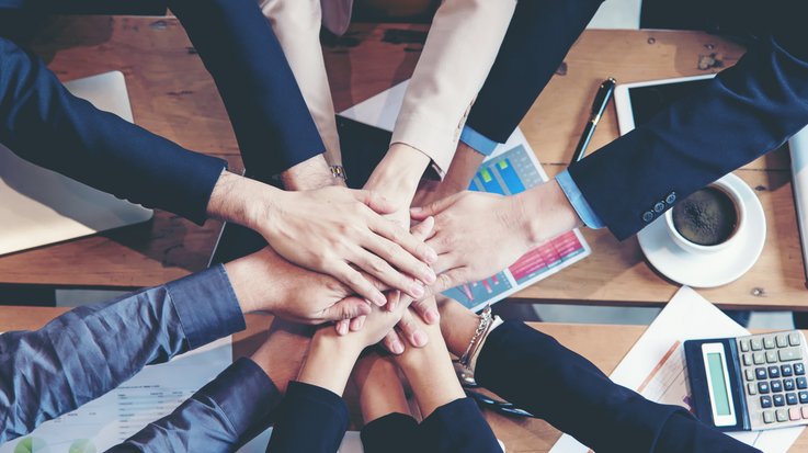 some people form a circle and put their hands on each other
