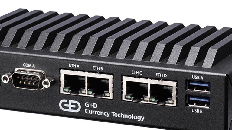 A small black box with USB, and various network cable ports and the inscription G+D Currency Technology.