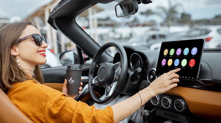Woman operates the cockpit of her convertible via touchscreen